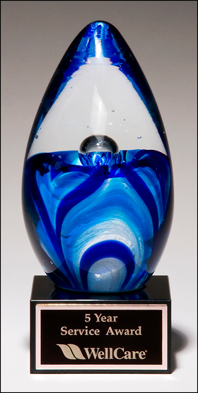 Art glass egg with blue and white accents on black glass base 1633