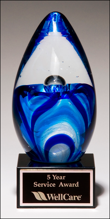 Art glass egg with blue and white accents on black glass base 1633