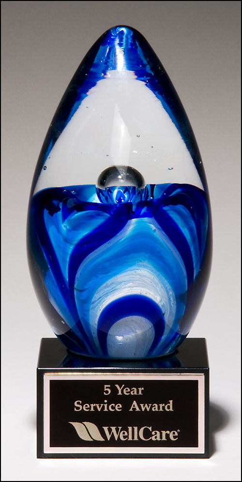 Art glass egg with blue and white accents on black glass base 1633